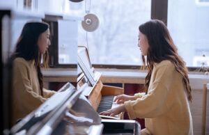A woman playing the piano to an online audience