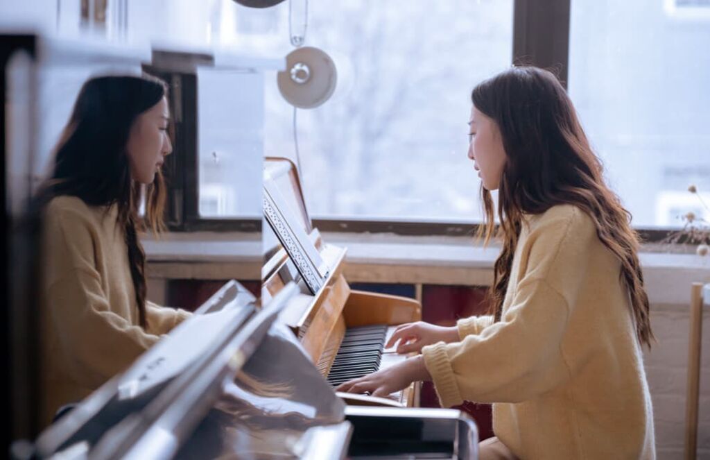 Eine Frau spielt Klavier vor einem Online-Publikum