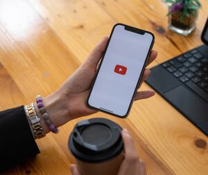 The YouTube app being opened on a phone.